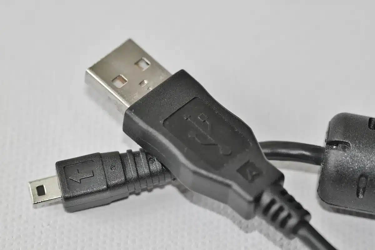 Controller da gioco turchese su tavolo con cavo di ricarica