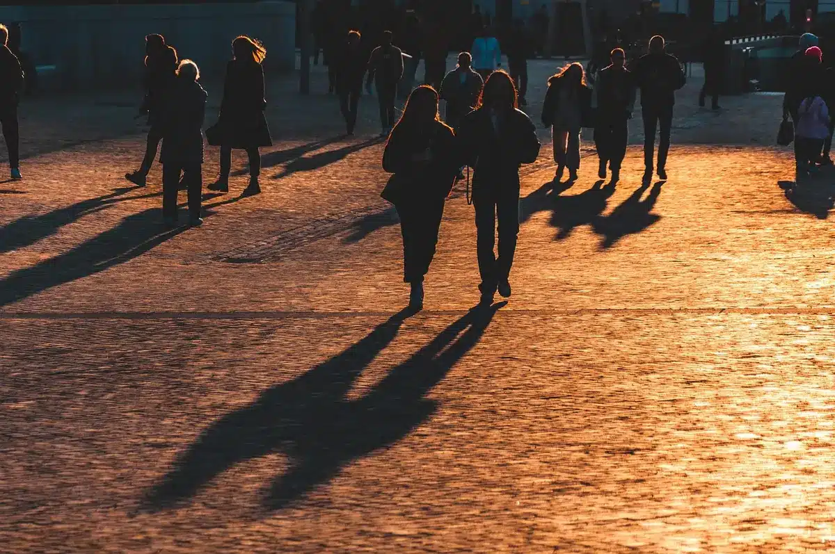 Persona che cammina in città con auricolari open-ear a clip