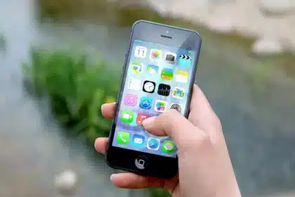 Mani anonime che scansionano uno scontrino con uno smartphone su un tavolo ben illuminato